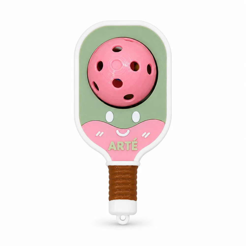 Bubbly Clicker: a soft green mini paddle charm with a pink ball and a smiling face