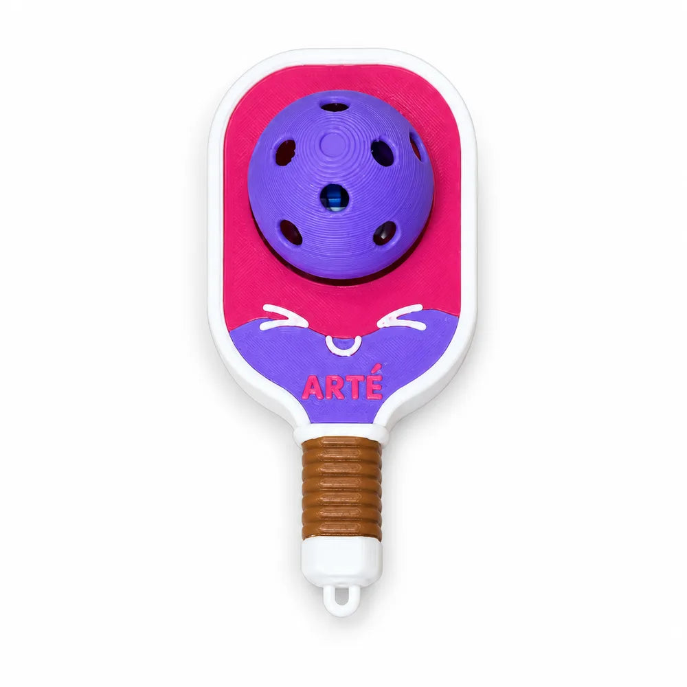 Spinny Clicker: a magenta and purple mini paddle charm with a ball and a smile